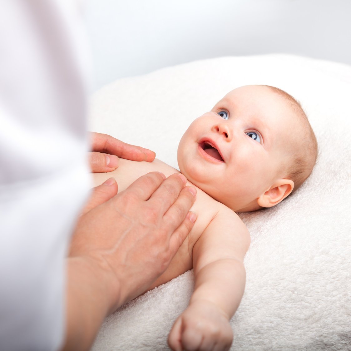 Person Massaging a Baby