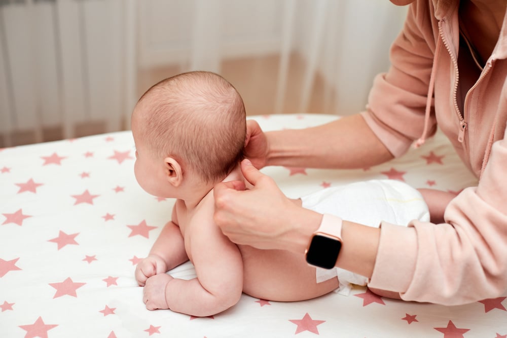 Baby Massage. Mother Massaging Her Newborn Baby.